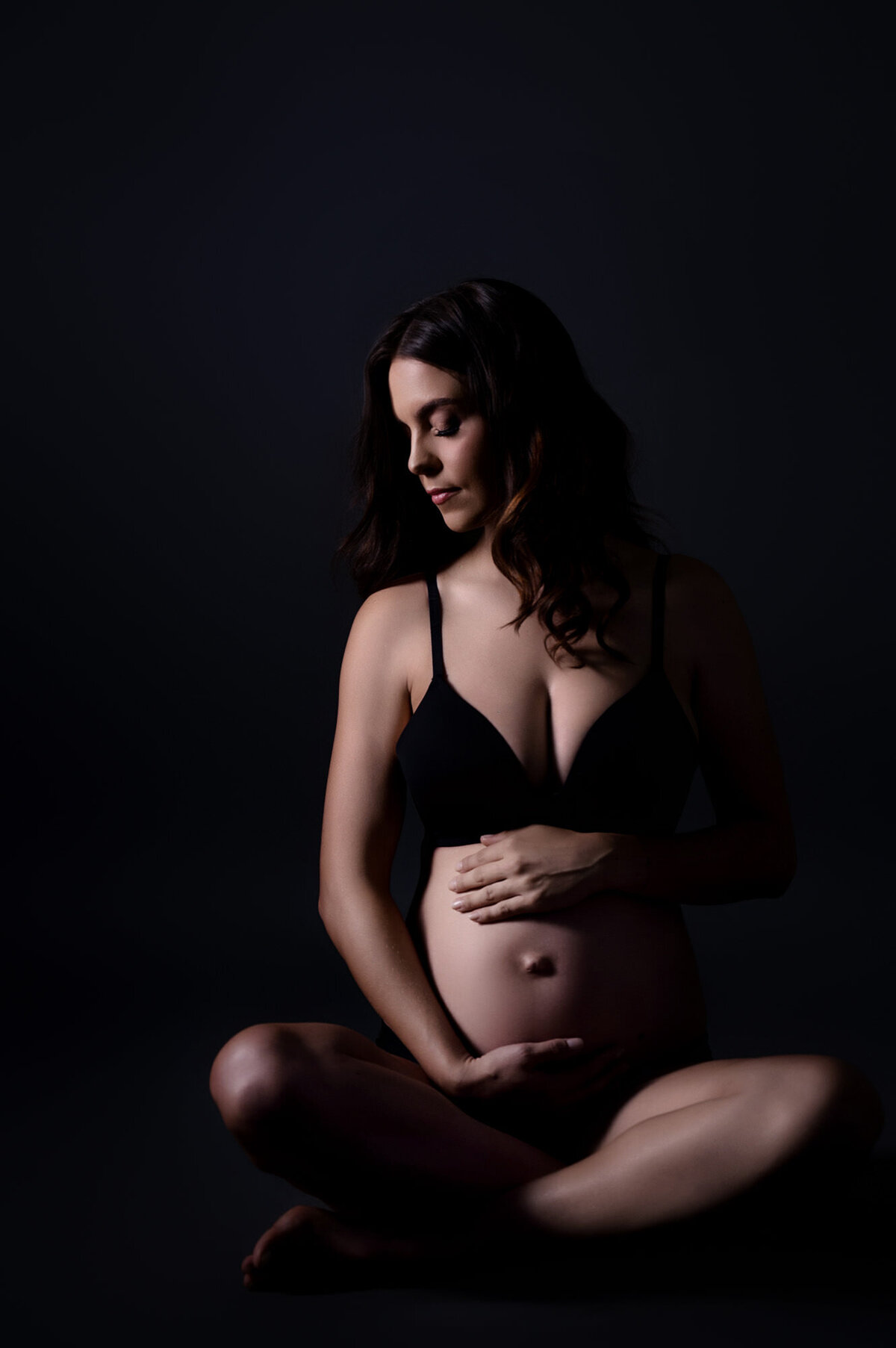 Intimate low-key maternity photo showing beautiful belly profile – maternity photography Pretoria