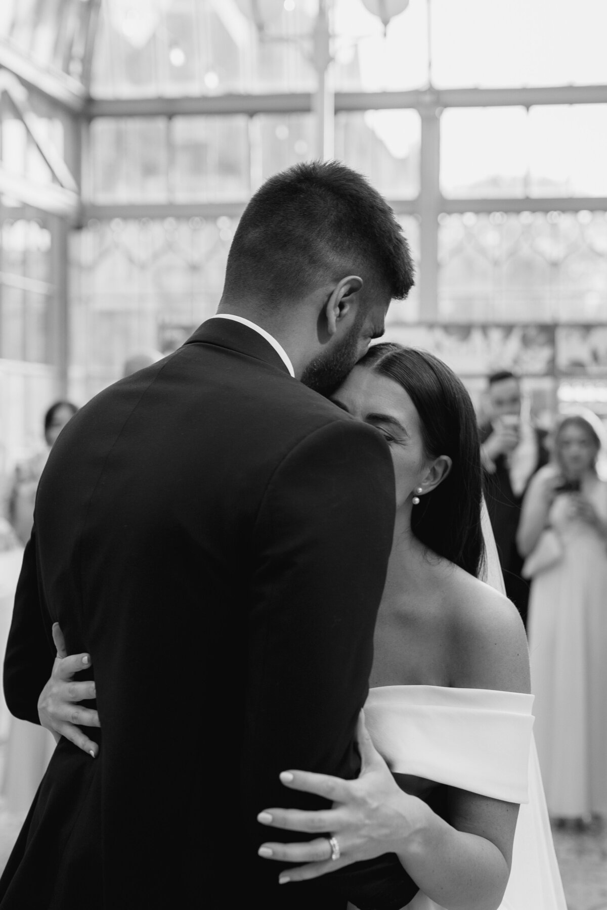 The bride and groom embrace during the first dance at Tortworth Court, Cotswold wedding venue