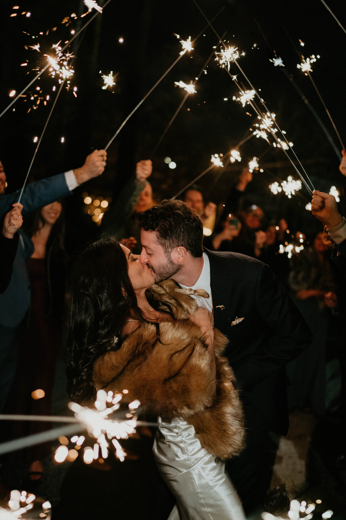 Bride and groom kissing during their sparkler send off after their wedding at Blockhouse