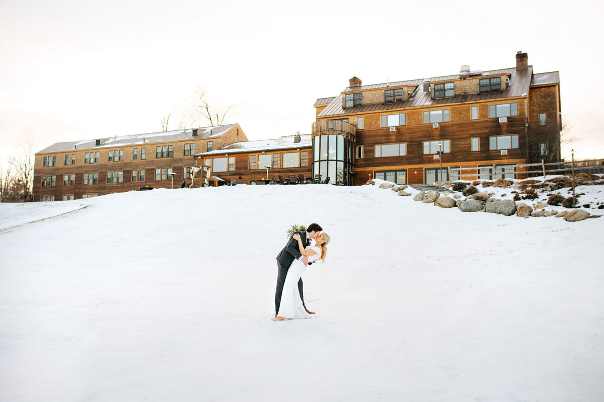 winter wedding at mountain top inn chittenden vermont couple kissing at sunset in snow