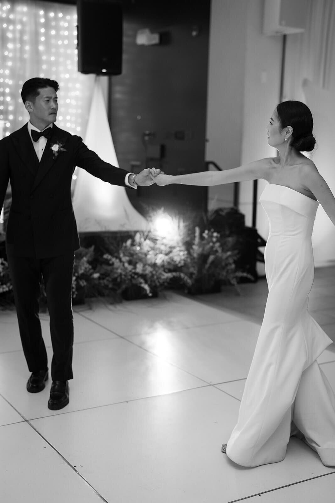 Groom invited Bride to the dancefloor for their first dance in front of friends and family at their Aspen Meadows Resort wedding reception.
