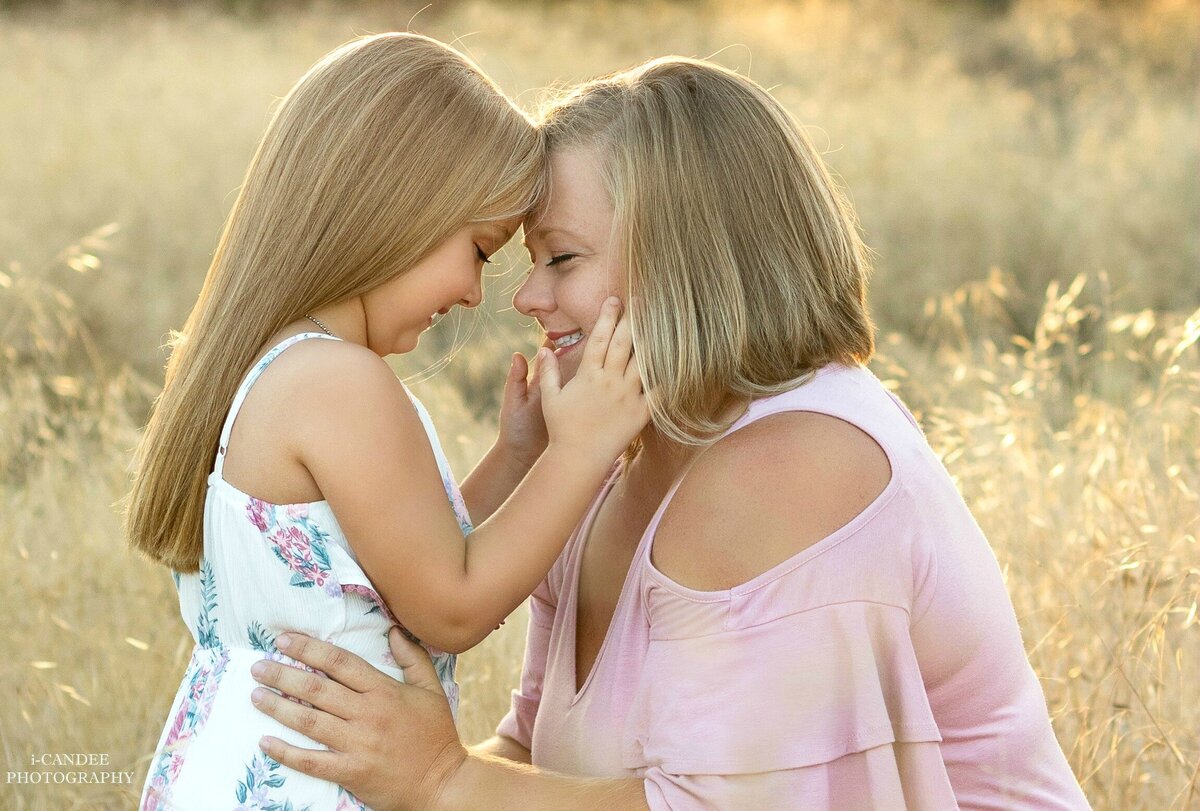 MOTHER AND DAUGHTER POSING FACE TO FACE