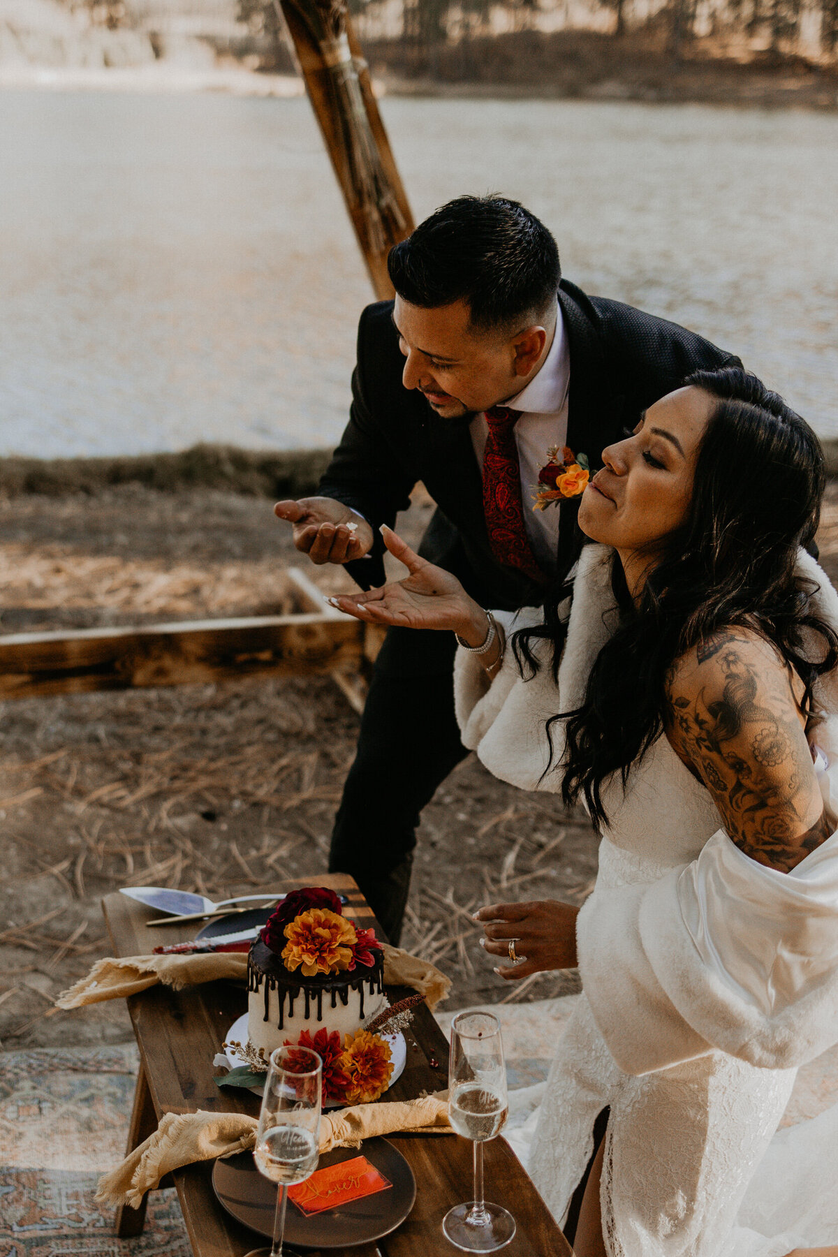 newlyweds cutting cake after their elopement ceremony