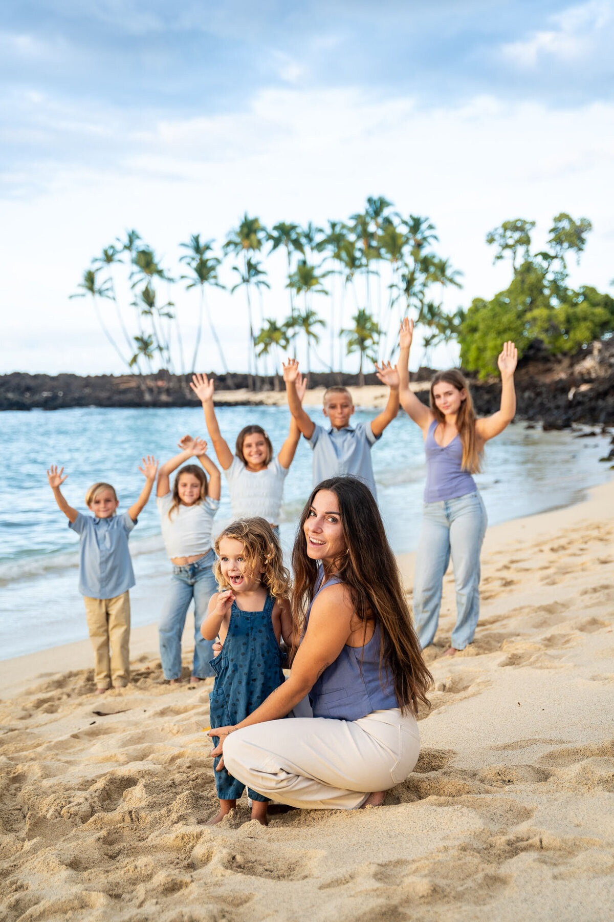 Family cheering on beach, taken by big island family photographer