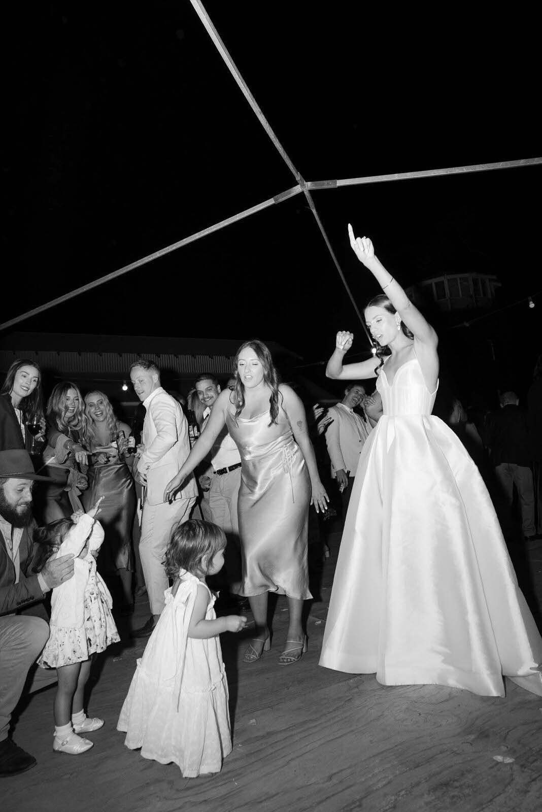 bride dancing with the flower girl