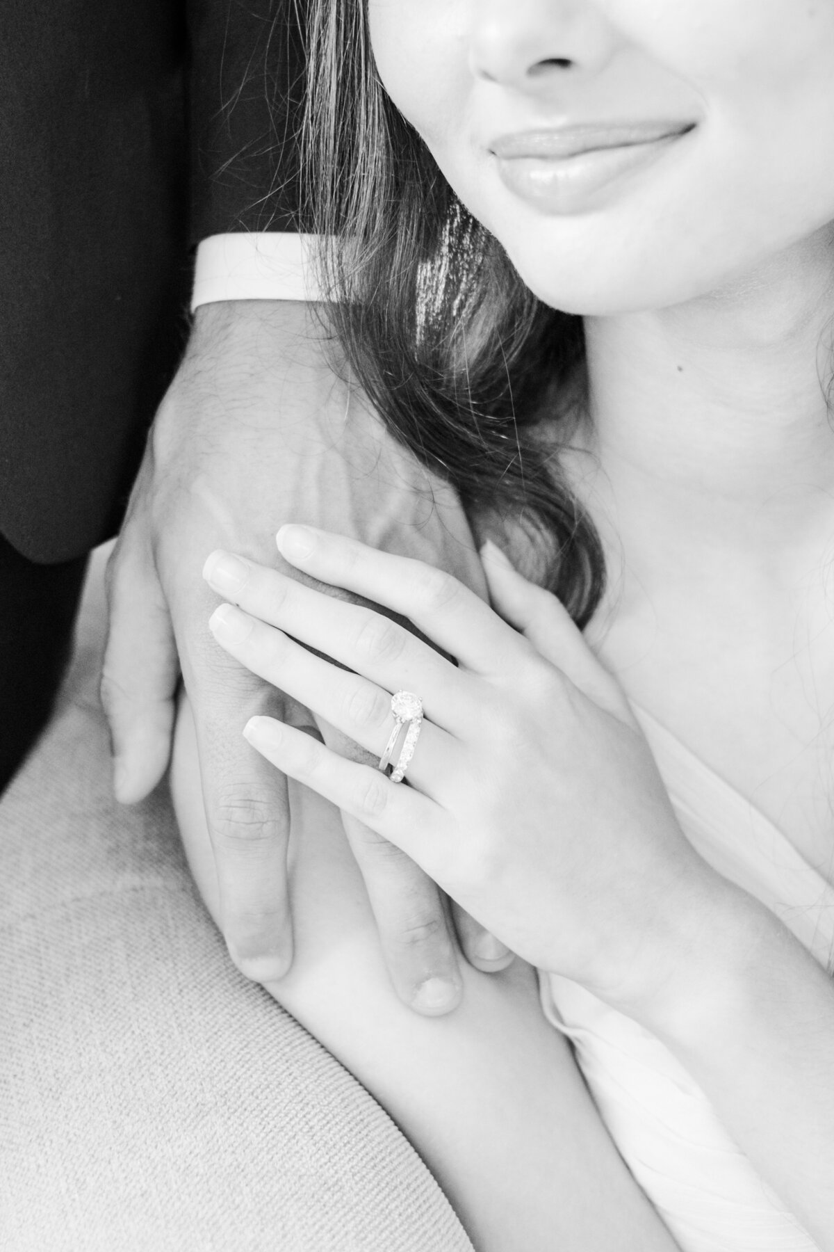 black and white image of bride holding groom's hand