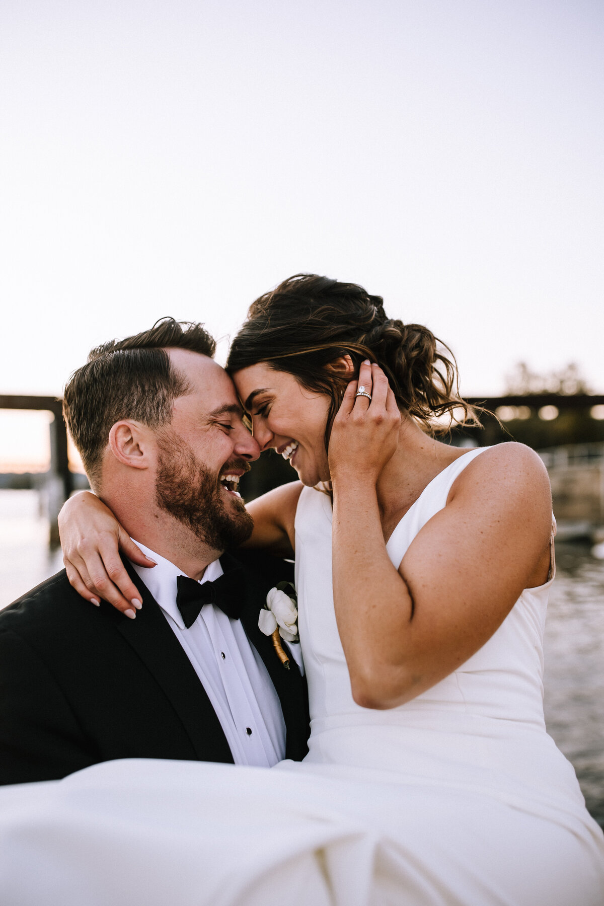 Bride and groom on a dock. 