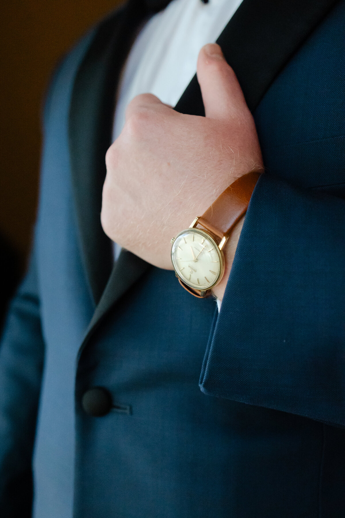 A groom and his heirloom watch getting ready