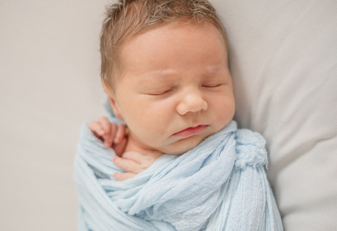 Cute newborn boy swaddled sleeping during newborn maternity photoshoot in Gold Coast QLD