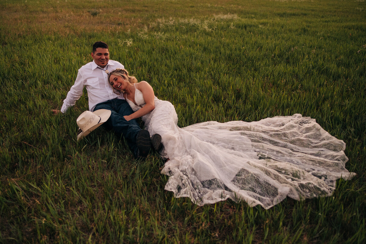 Bride and groom lying on grass