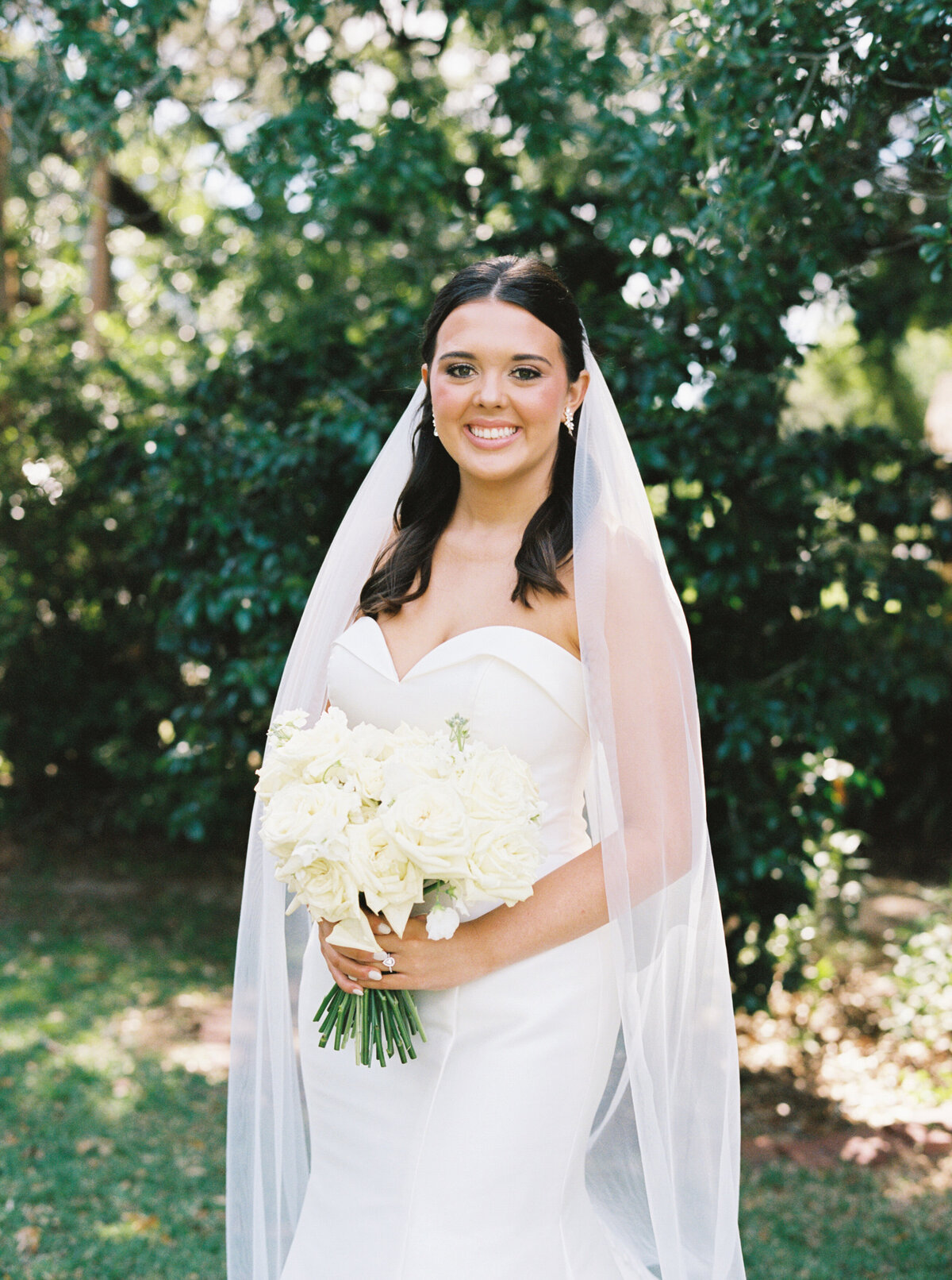 A timeless bridal portrait set against the backdrop of the 1891 Victorian mansion, the John Nickerson House in Lafayette, LA, beautifully captured on film by Morgan Alysse, Louisiana film photographer.