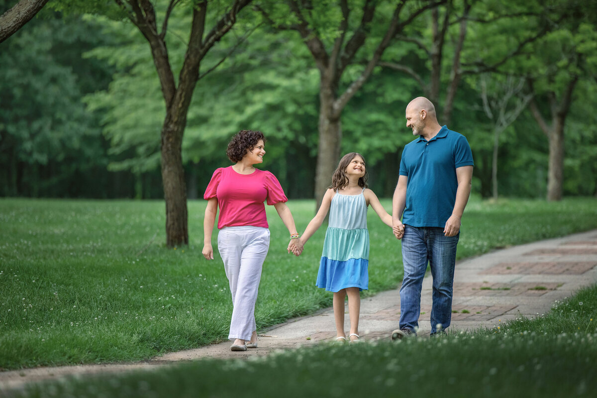 Family holds hands walking for  family photography  session in South Jersey