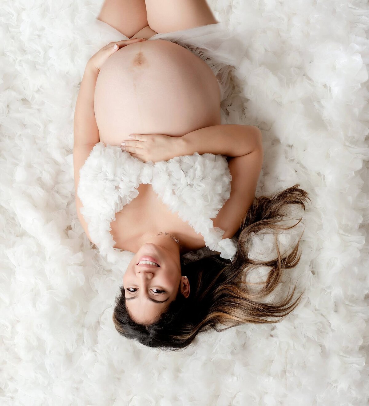 A stylish expectant mother radiating happiness in a Brooklyn Studio maternity shoot.