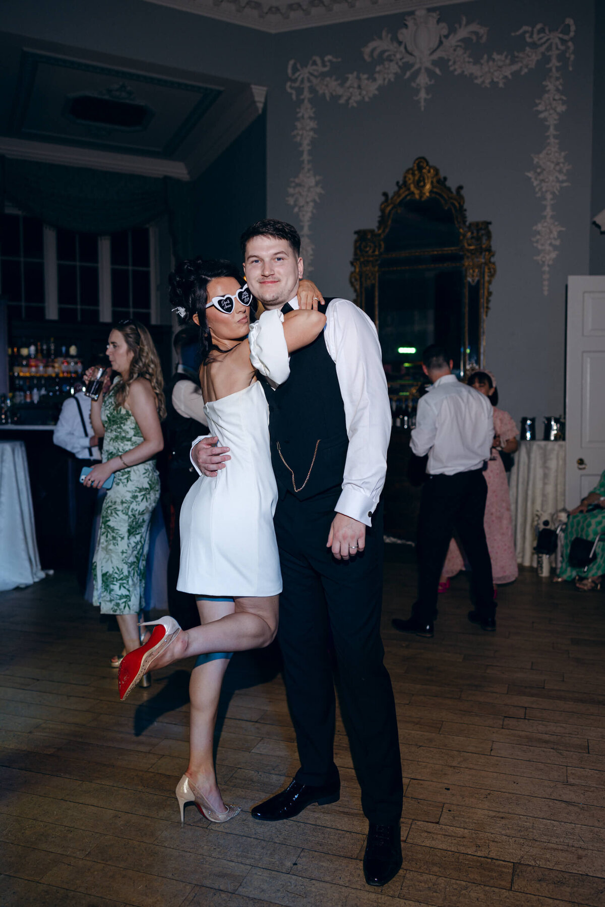 A wedding photo of the bride and groom celebrating during their reception at their wedding at Luttrellstown Castle in Dublin Ireland