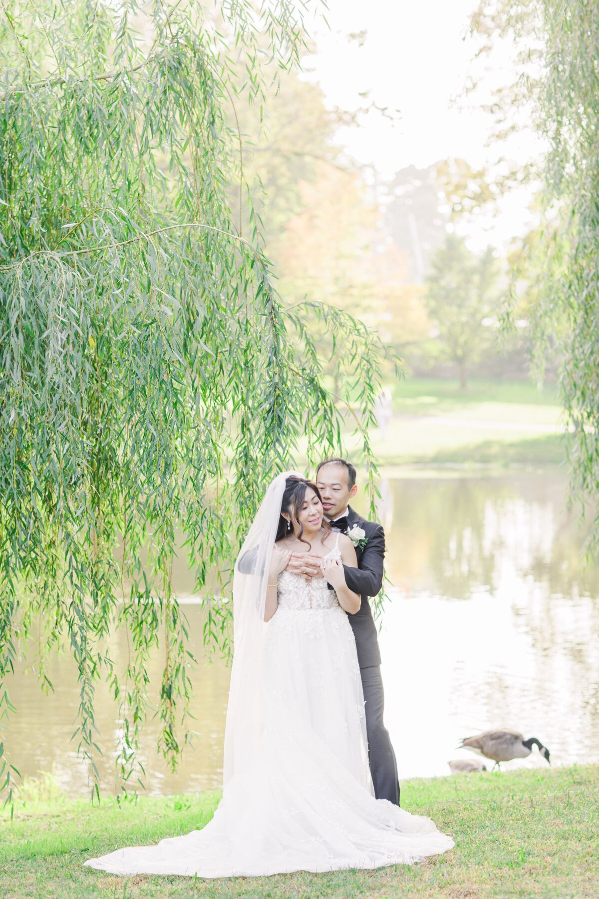 Bride and groom snuggling at Larz Anderson Park representing timeless Boston wedding photography