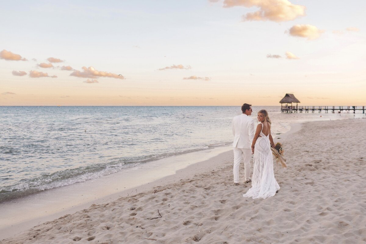 Bride and groom walking on beach viceroy riviera maya wedding