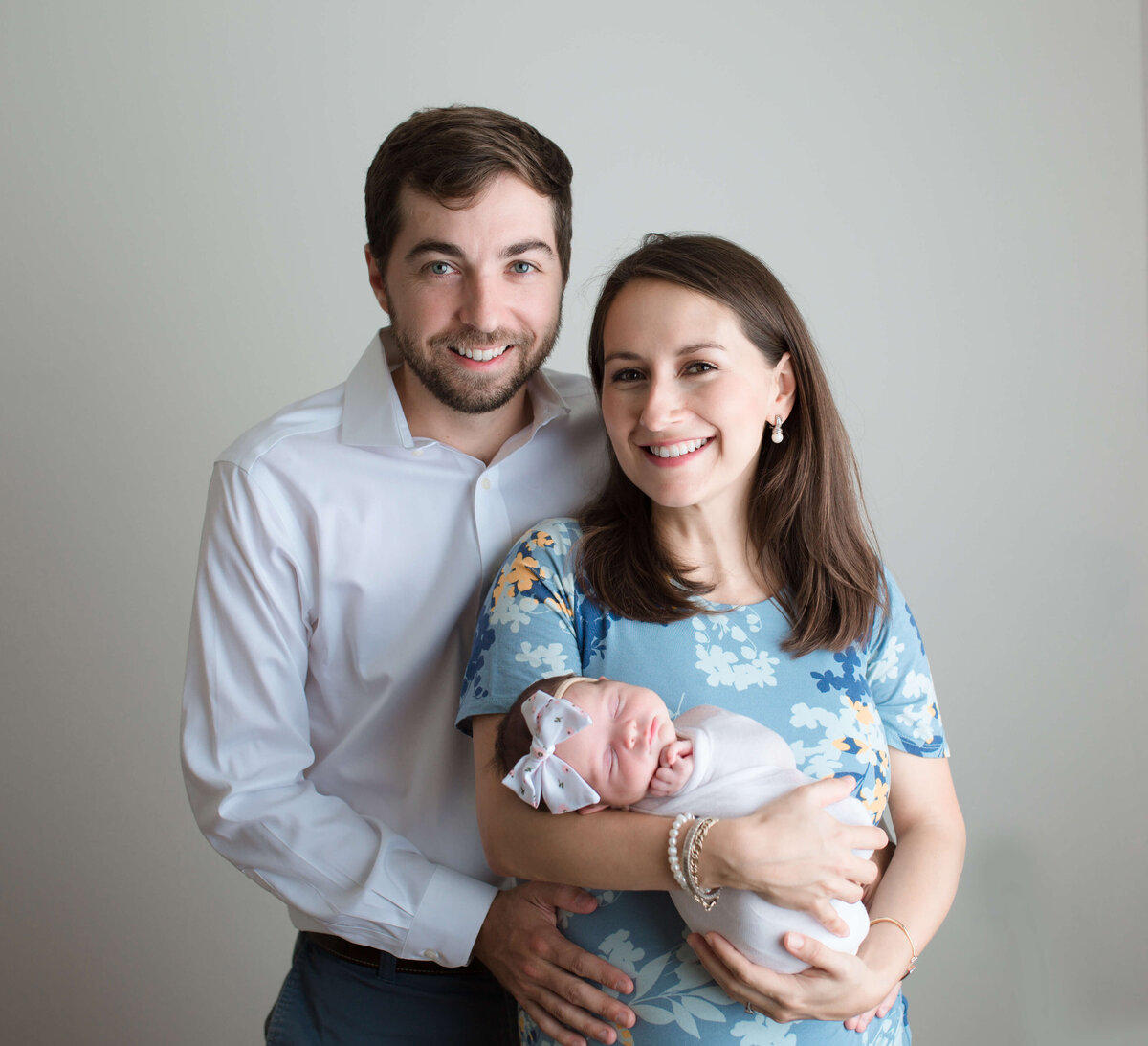 New parents holding their baby girl in seattle studio