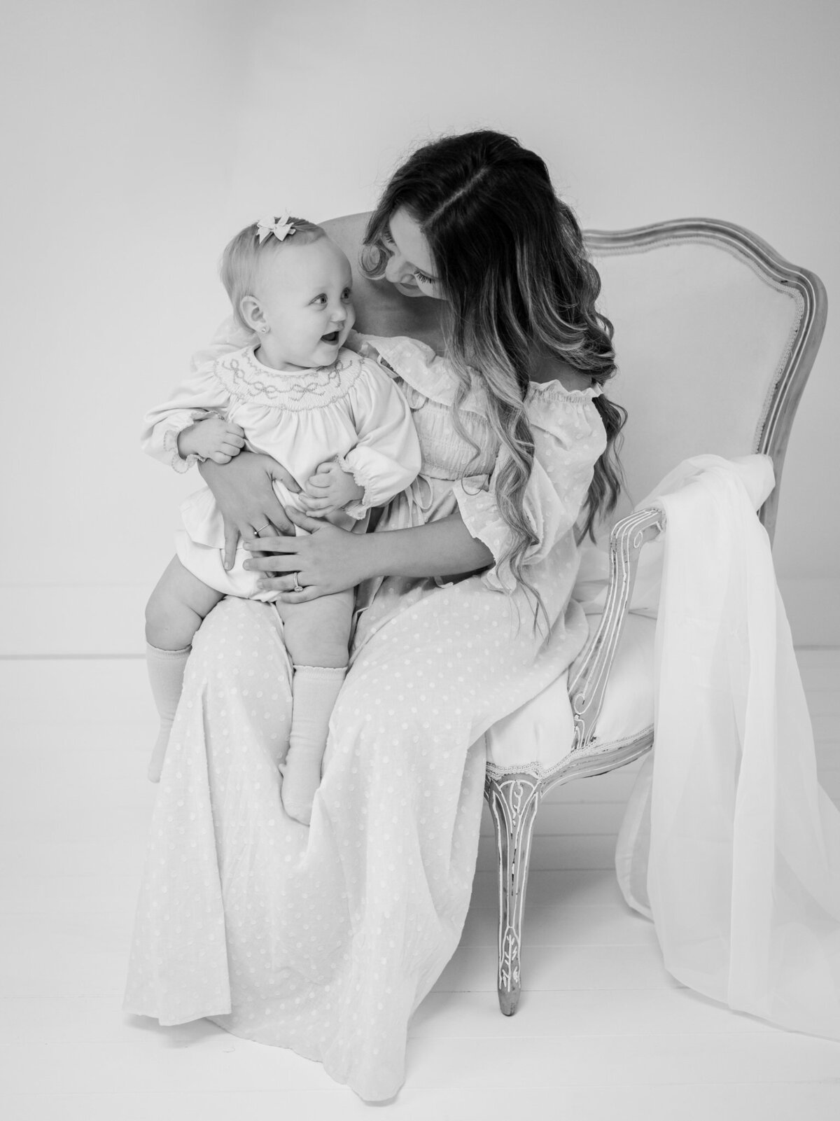 Precious black and white image of mom with her baby laughing during a Motherhood session. Joyfully serving mothers and babies in Southwest Georgia & Northwest Florida. 