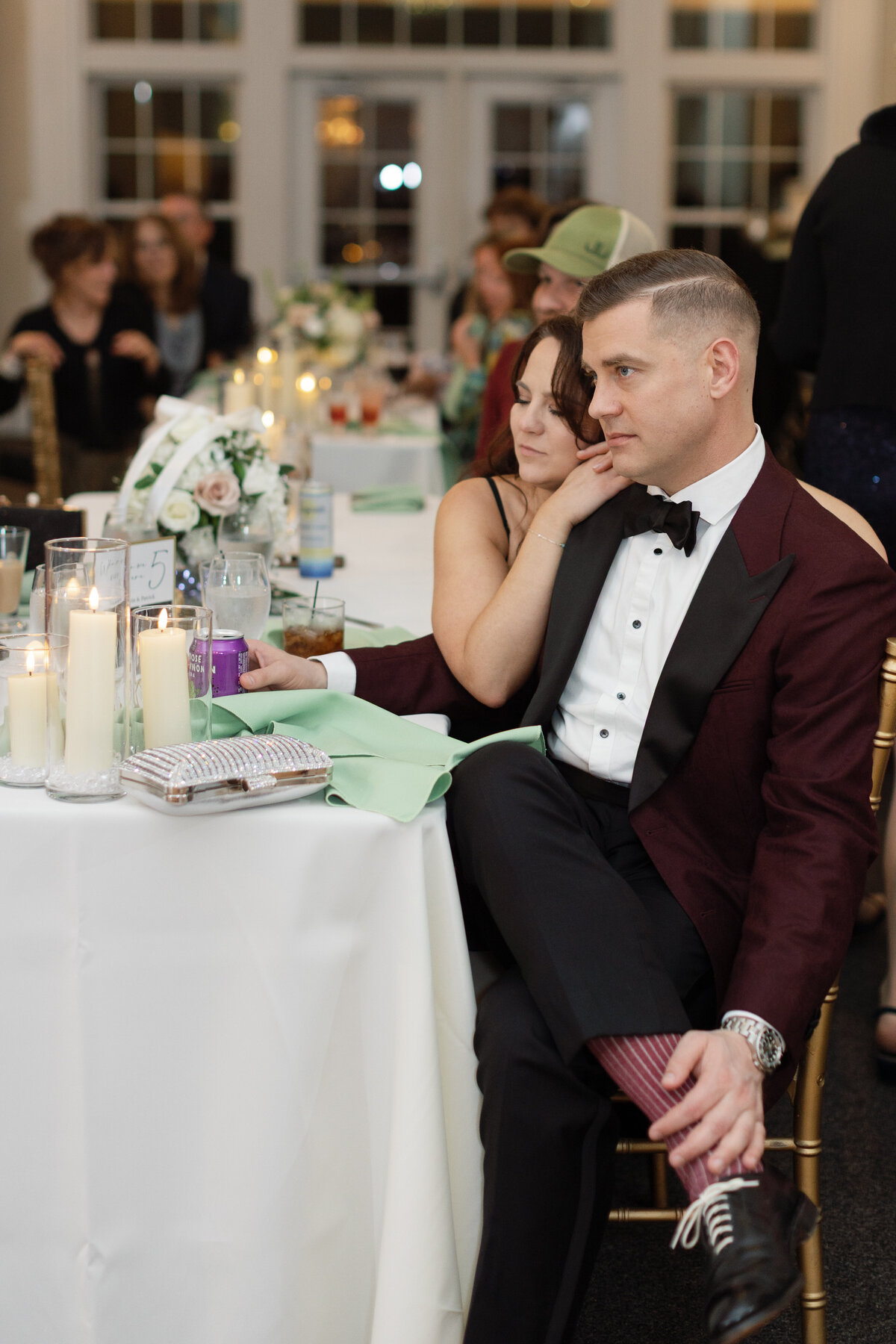 Wedding guests listen to speeches at black tie wedding
