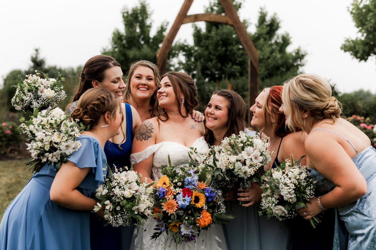 A bridal party cuddles close and shares some laughs.