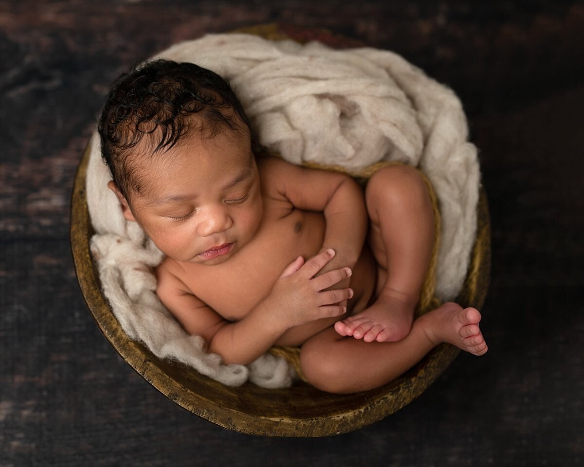 newborn-boy-curled-up-in-bowl