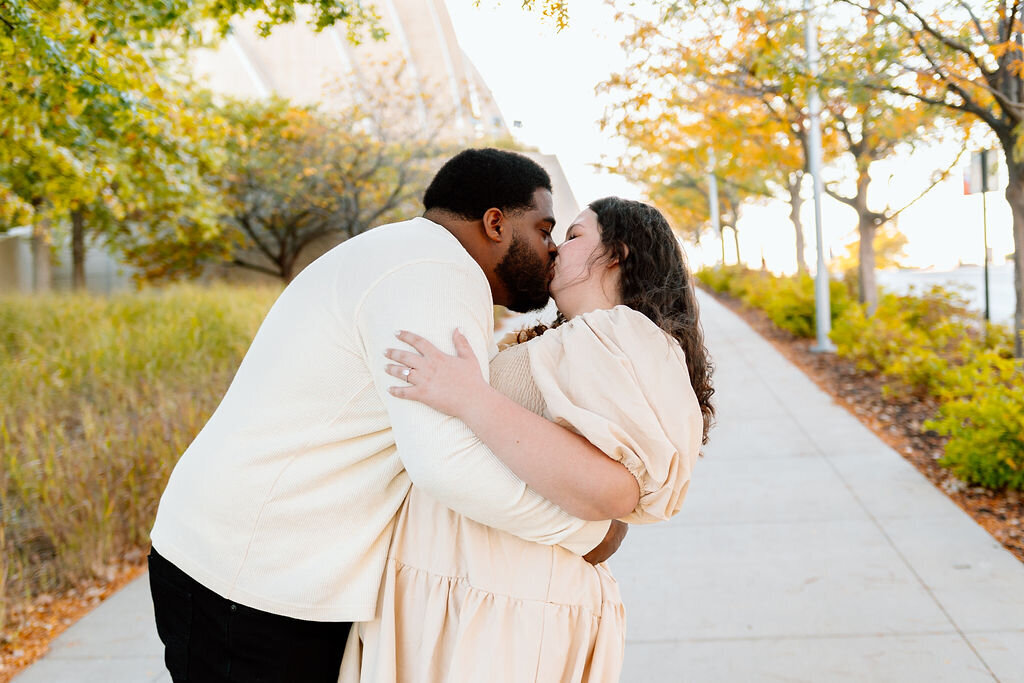 couple shares a kiss during engagement photoshoot in kansas city missouri