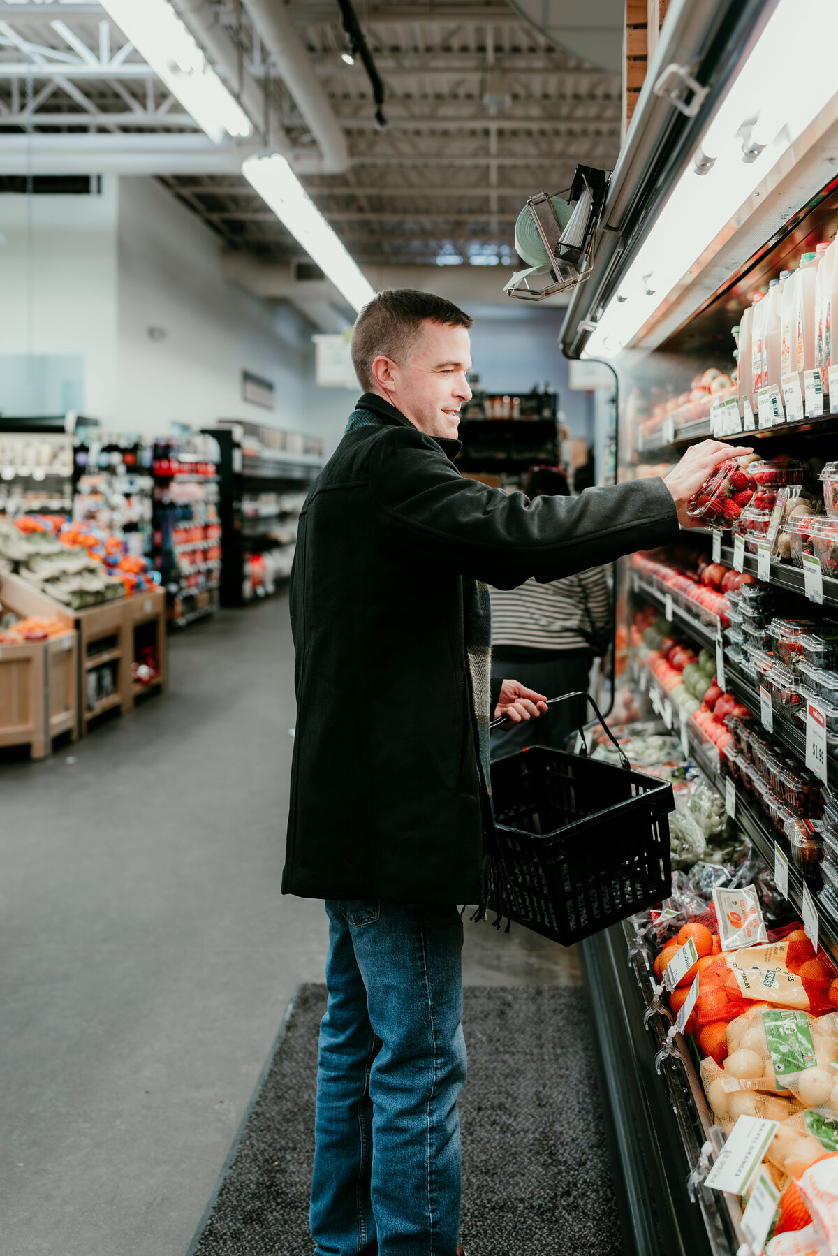 Man reaching for an item in a grocery store, highlighting natural and candid moments for a unique dating profile photo.