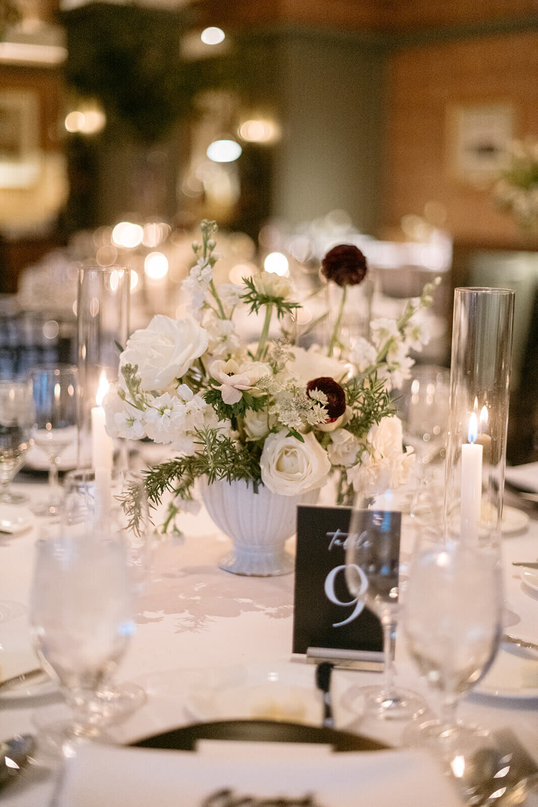 Wedding reception table at St. Regis Aspen, featuring refined place settings, floral arrangements, and candlelight