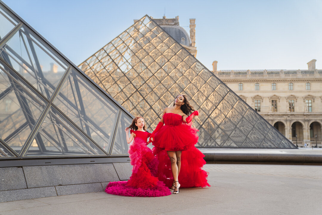 Fairytale-inspired mommy and me shoot at the Louvre with fluffy red and pink dresses
