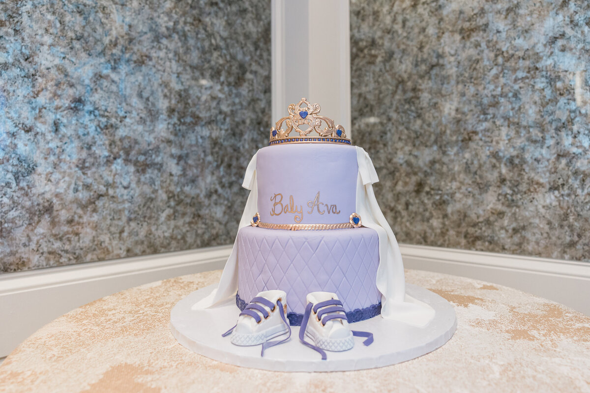 Purple princess cake with shoes for baby shower at The Four Seasons.