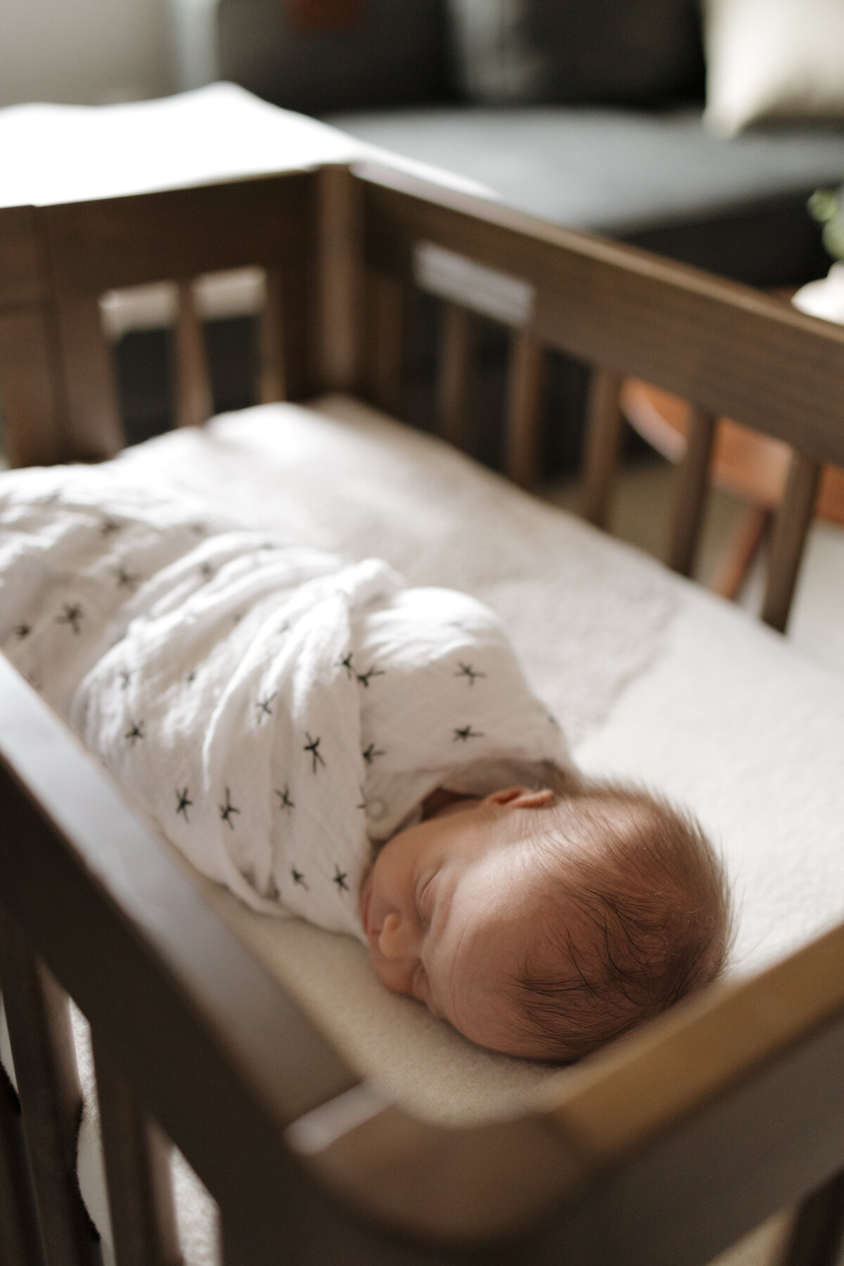 Longmont newborn swaddled in star blanket sleeping during in home newborn session with alexis adkins photo