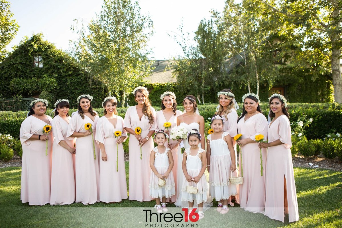 Bride poses with her bridesmaids prior to the ceremony