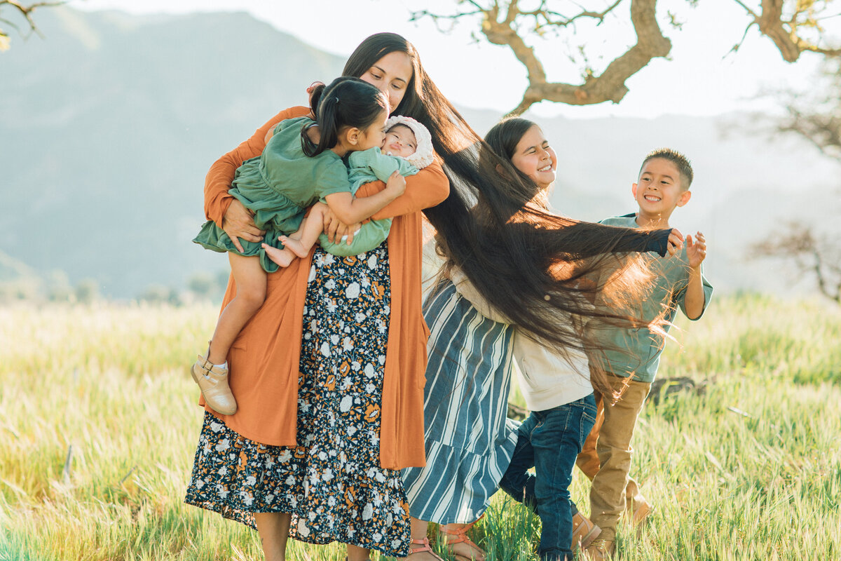 Family Portrait Photo Of Kids Playing With Their Mother's Hair Los Angeles