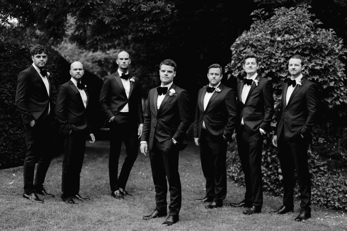 groomsmen in black tie looking to camera at a manchester wedding