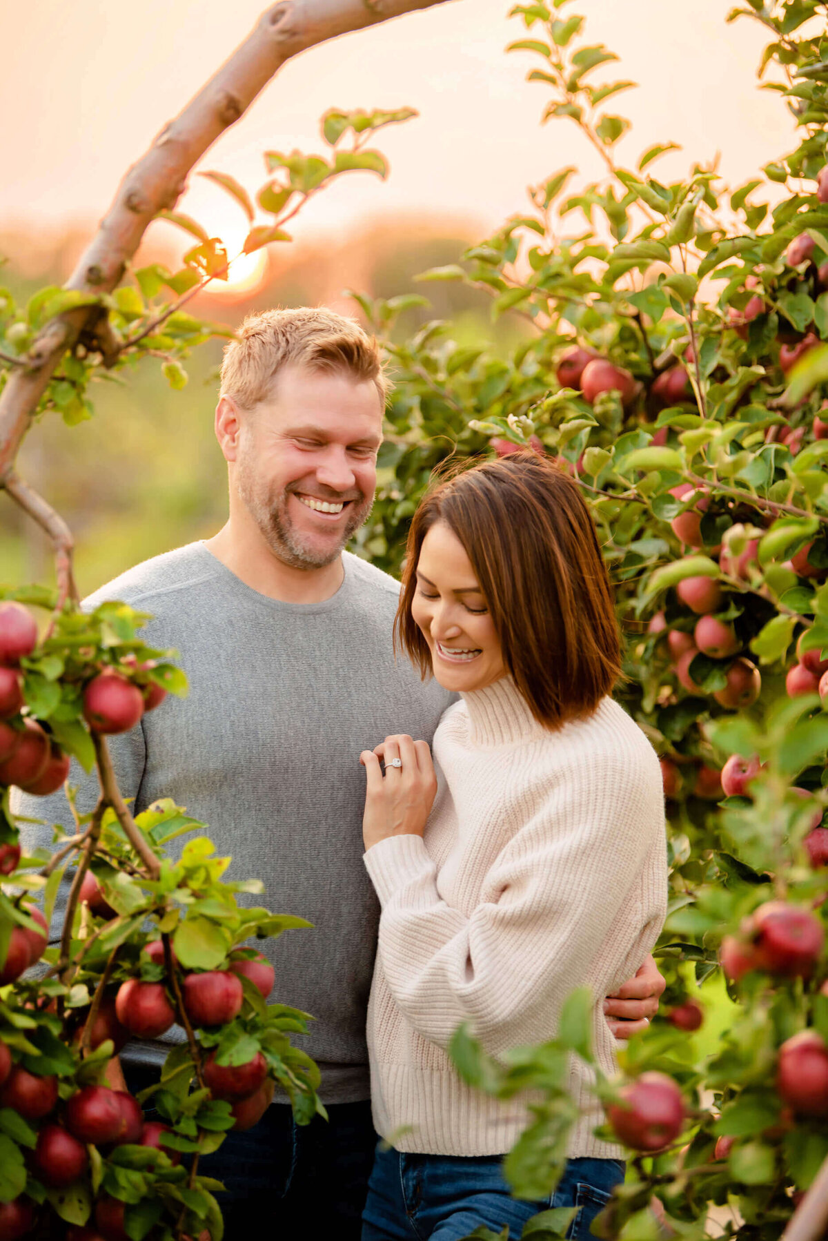 Mom and dad laughing together in their fall family photos in Burlington