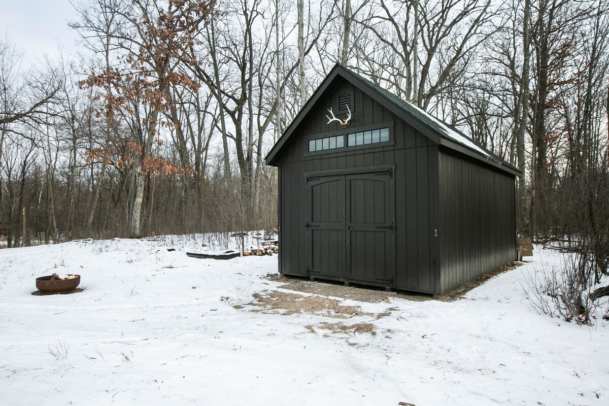 Exterior back view of custom home in Elk River, Minnesota with black shed