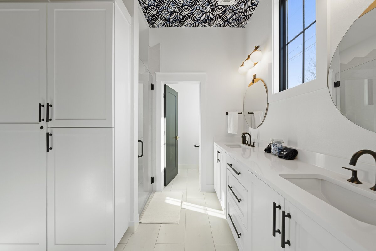 Spacious double vanity bathroom with generous storage space in this two-bedroom, two-bathroom house with wine fridge, firepit, and two master suites located in the heart of the Silo District in Waco, TX.