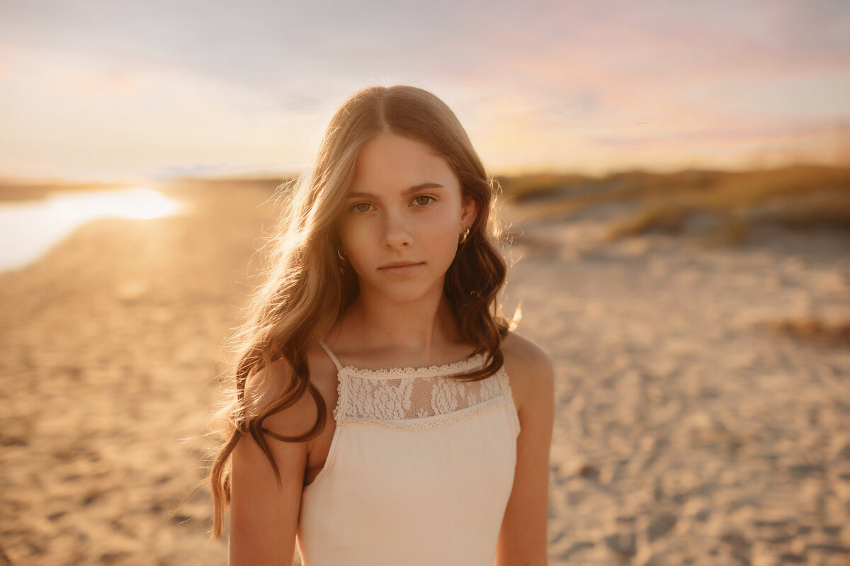 Girl peers into the camera during Family Photos on the Beach in Isle of Palms.