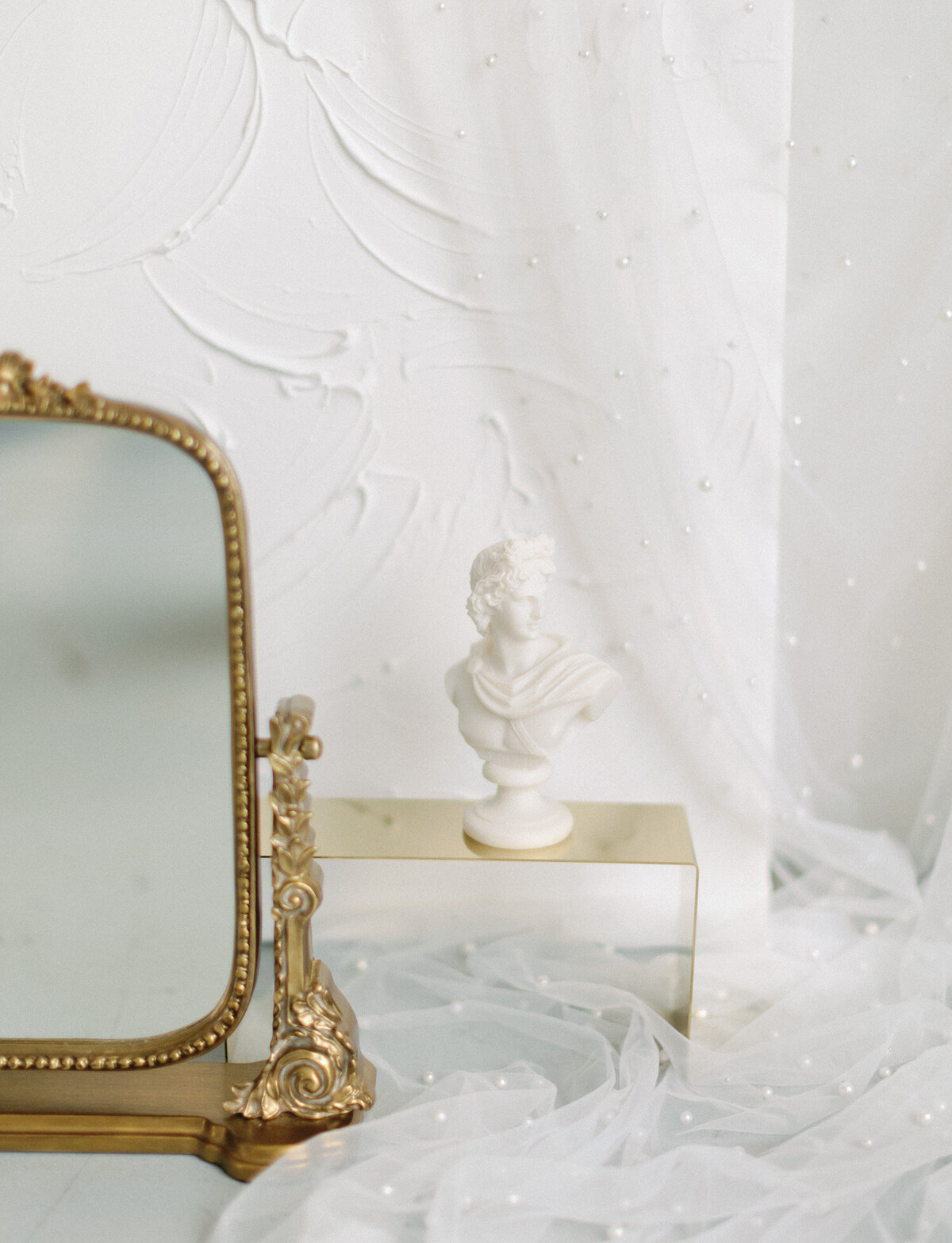 gold anthropologie mirror, sculpture bust candle ivory, details for florist branding photos in Michigan