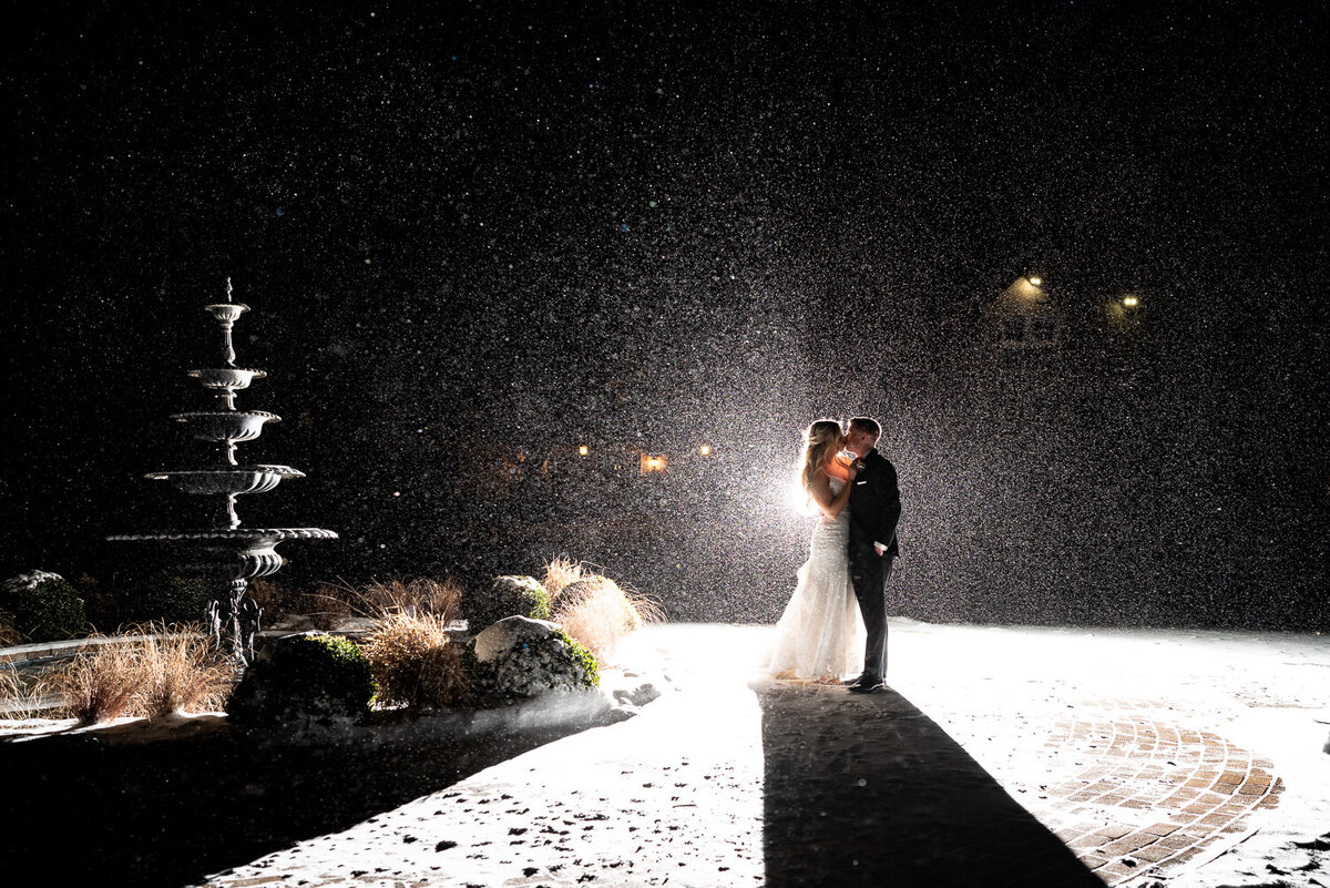 Bride and groom kiss in the snow at Bavaria Downs in Chaska, Minnesota.