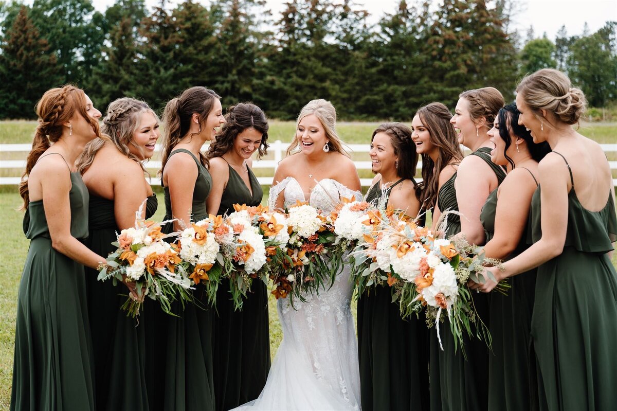 Bridde and bridesmaids wearing olive green dresses during portraits