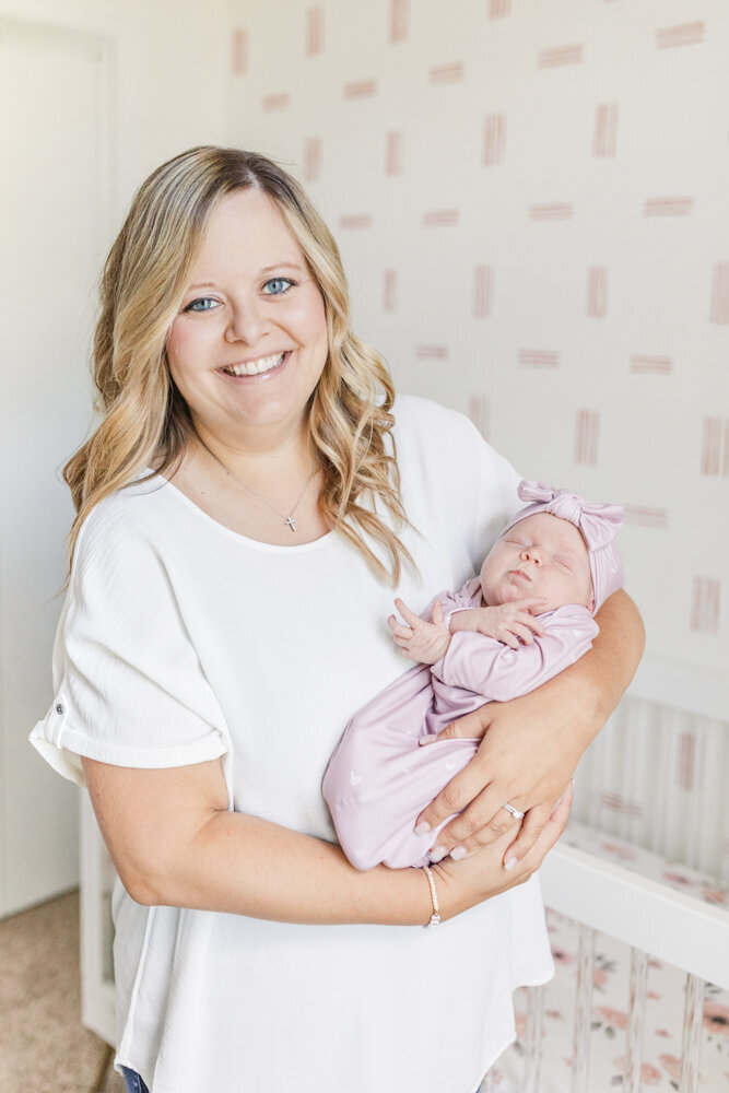 a woman holding her newborn baby