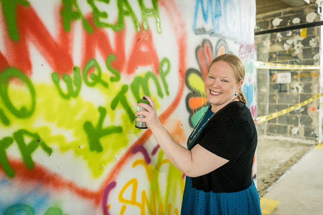 Corporate event photography of man painting colorful mural wall during team building session new jersey