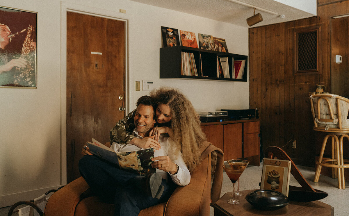 woman leaning over man during during in home couples photos, captured by Elsie Goodman, an NYC engagement and couples photographer