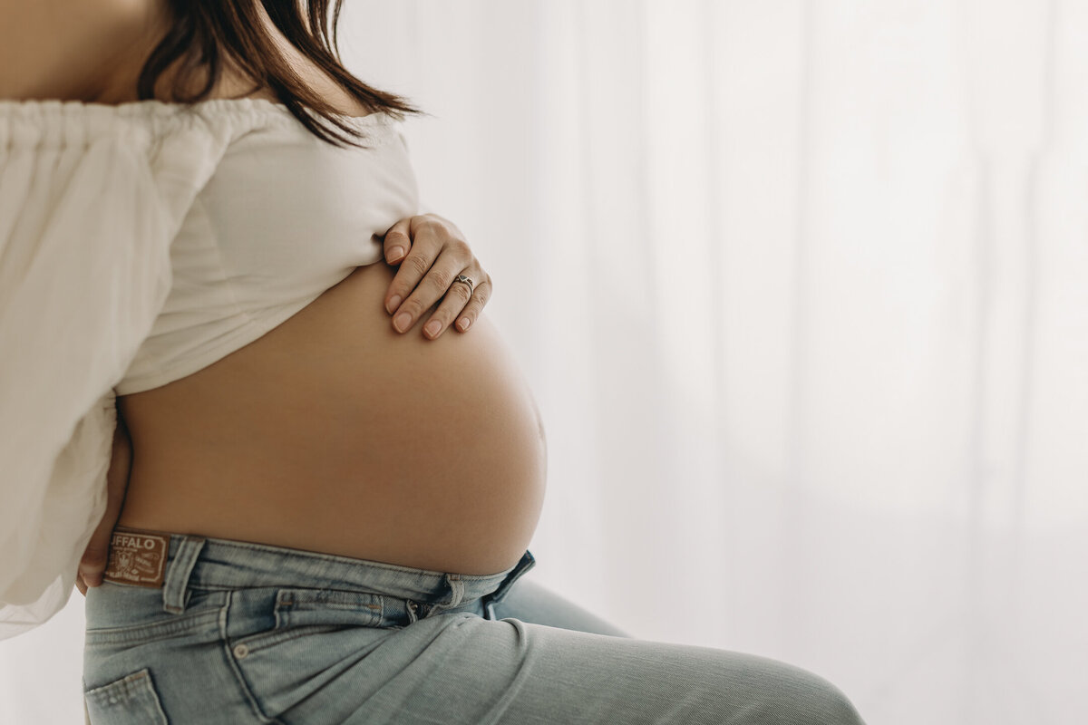 baby bump with jeans and white top