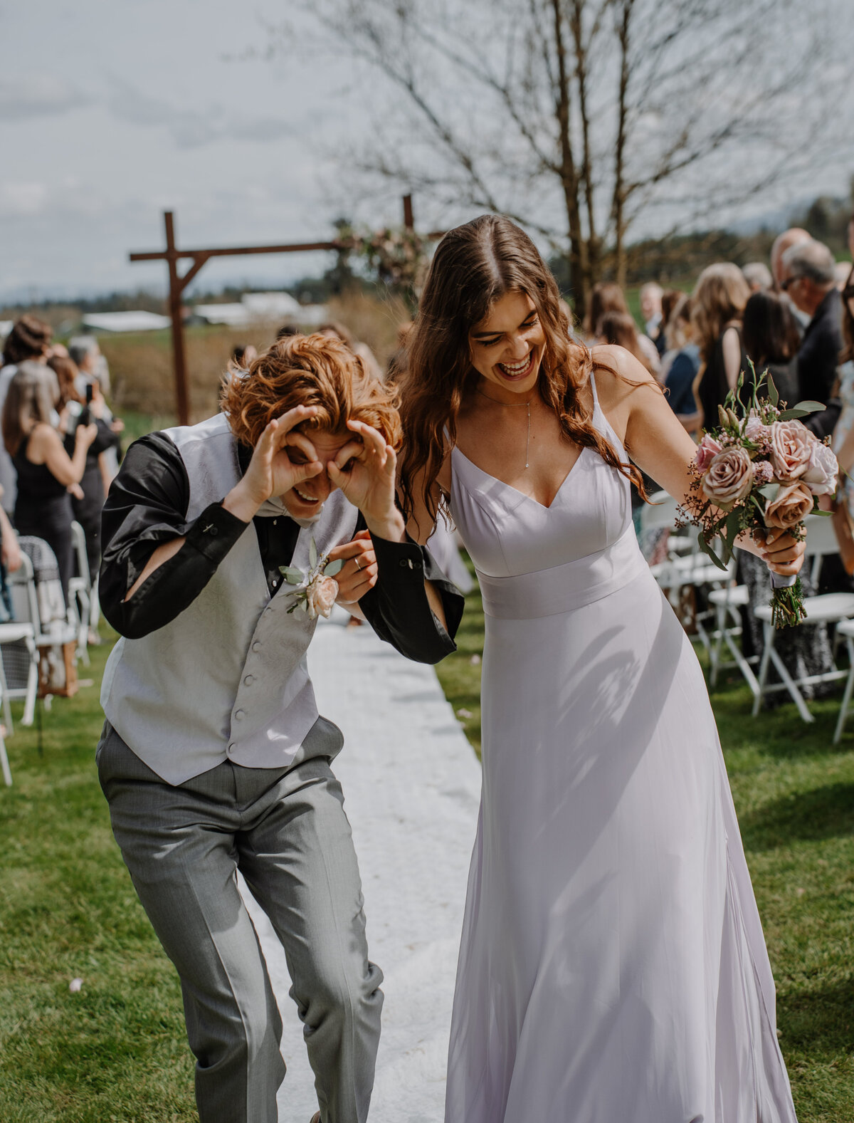 two young people dancing down isle