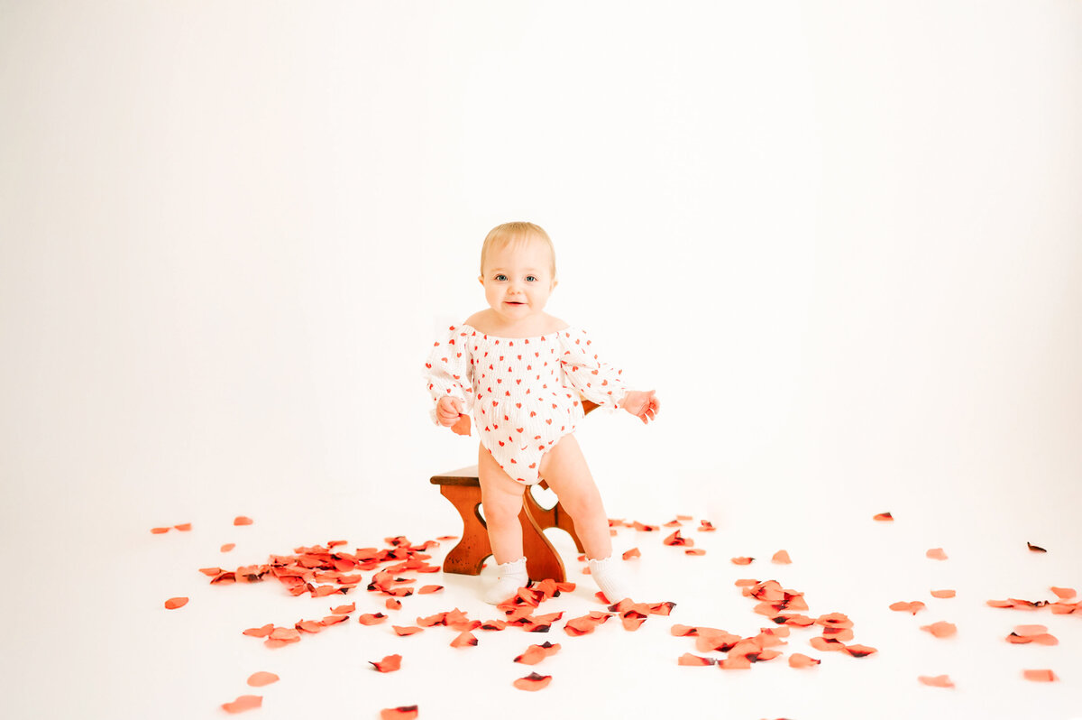 Springfield MO kids photography of toddler girl walking in rose petals