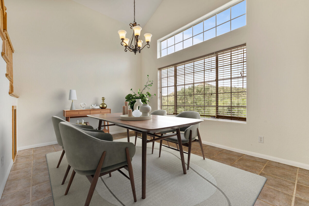 Bright white formal dining with large windows. Virtually staged with contemporary furniture.