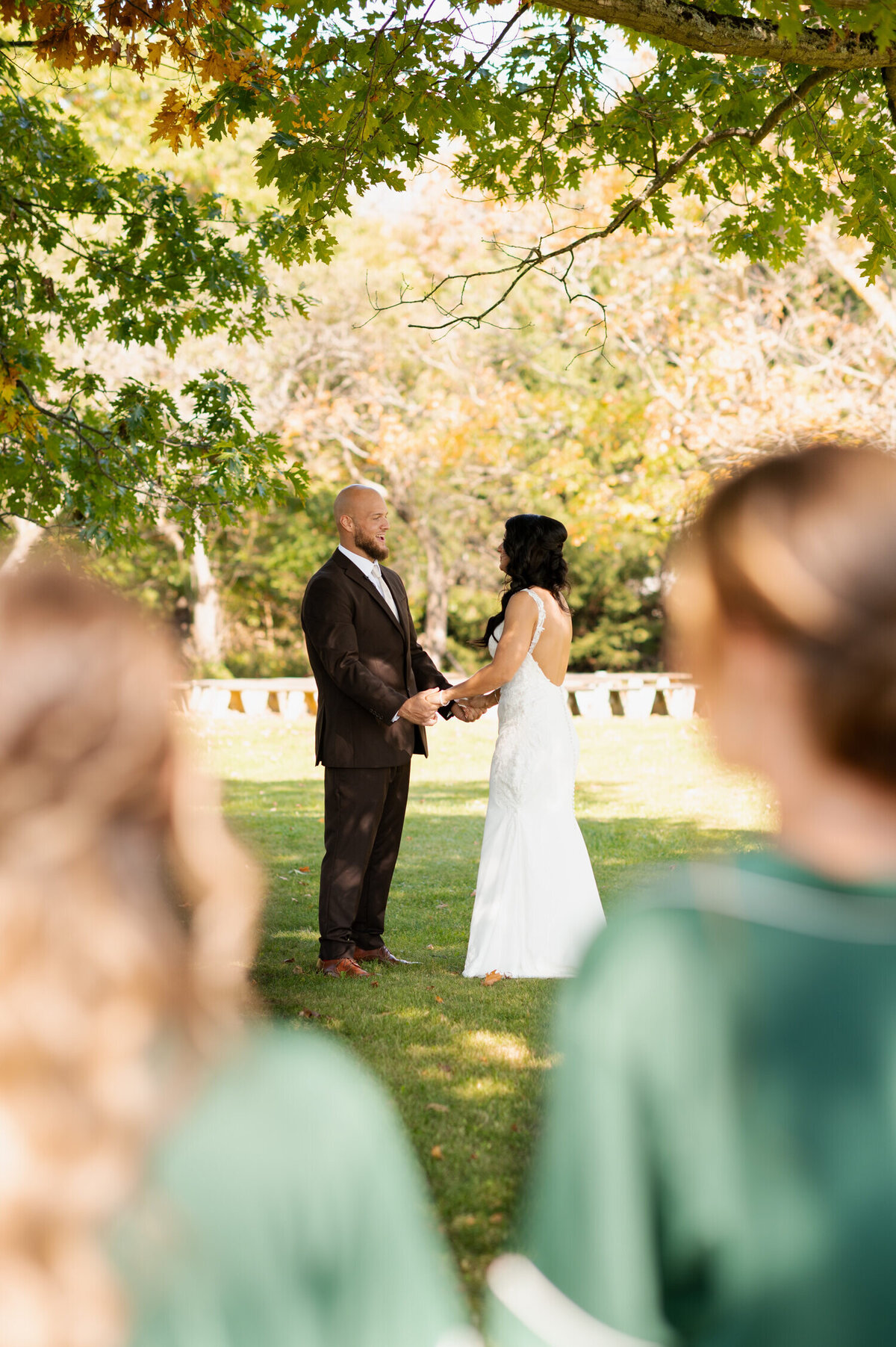 A candid photo of the bride and groom's first look during a Fall wedding at Knotting Hill Farm in Jordanville, NY.