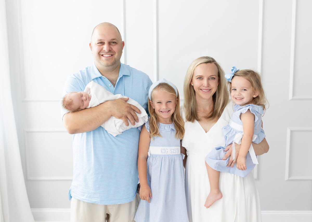 Family posing in studio for a newborn session